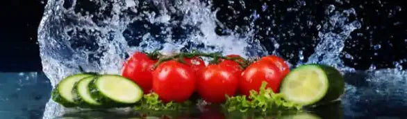 Tomatoes and cucumber slices in a splash of water