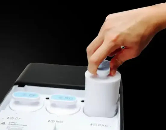 Hand turning a U1 filter cartridge a quarter turn to remove it