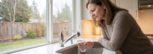 Homeowner checking the smell of tap water after rain