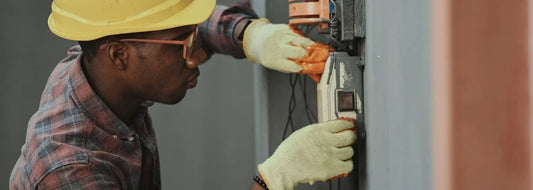 Technician inspecting home utility equipment for hard water scale clues