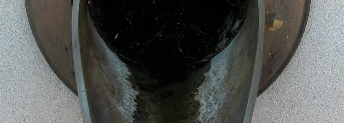 Close-up of water dripping from a pipe during a home leak inspection
